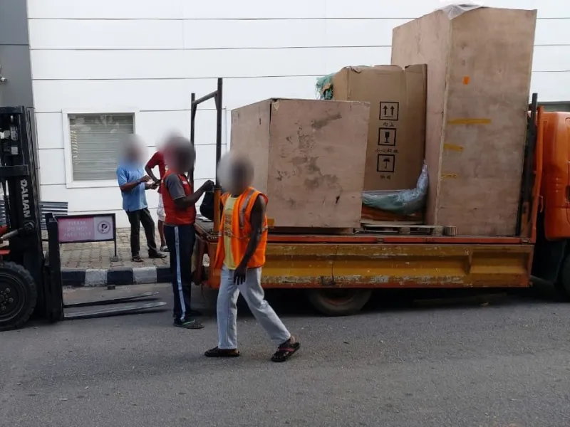 Crated equipment arriving on a delivery truck at the hospital